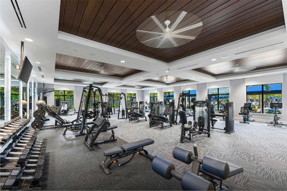 Interior view of the fitness center at a GL Homes community in Naples, showcasing modern exercise equipment and wellness amenities for residents.