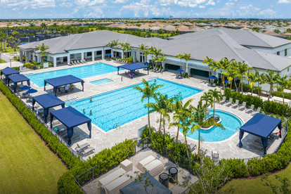 Aerial view of several outdoor fitness and lap pools and the sports complex promoting an active, healthy lifestyle in GL Homes’ Riverland community in Port St. Lucie. 